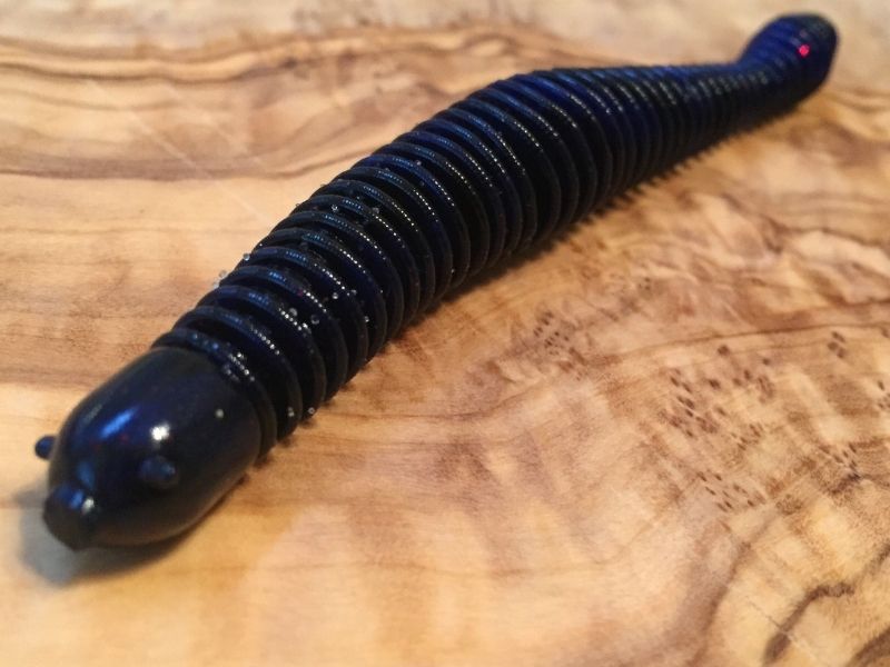 https://www.luckytacklebox.com/wp-content/uploads/2022/02/long-black-worm-bait-on-the-wooden-surface.jpg