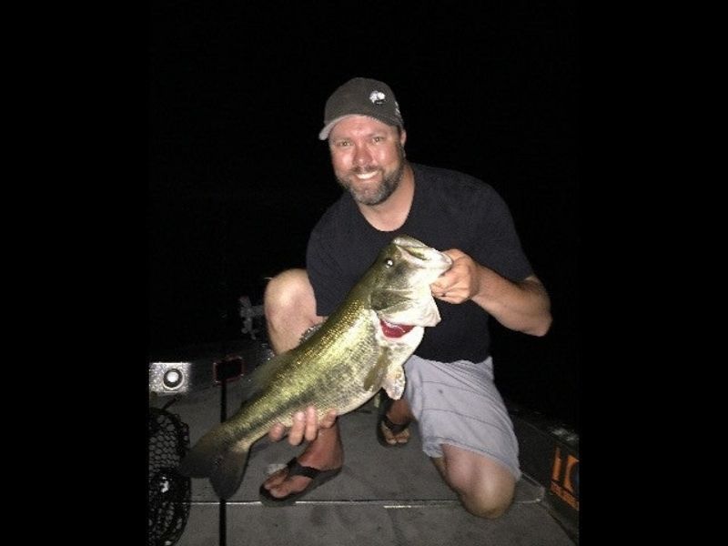 https://www.luckytacklebox.com/wp-content/uploads/2022/02/man-with-a-hat-holding-large-fish-at-night.jpg