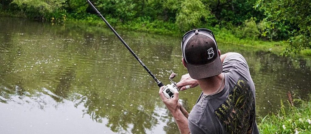 https://www.luckytacklebox.com/wp-content/uploads/2022/03/man-with-a-hat-holding-a-rod.jpg